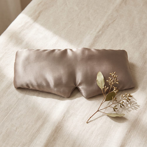 Taupe plush mulberry silk sleep mask on cream linen